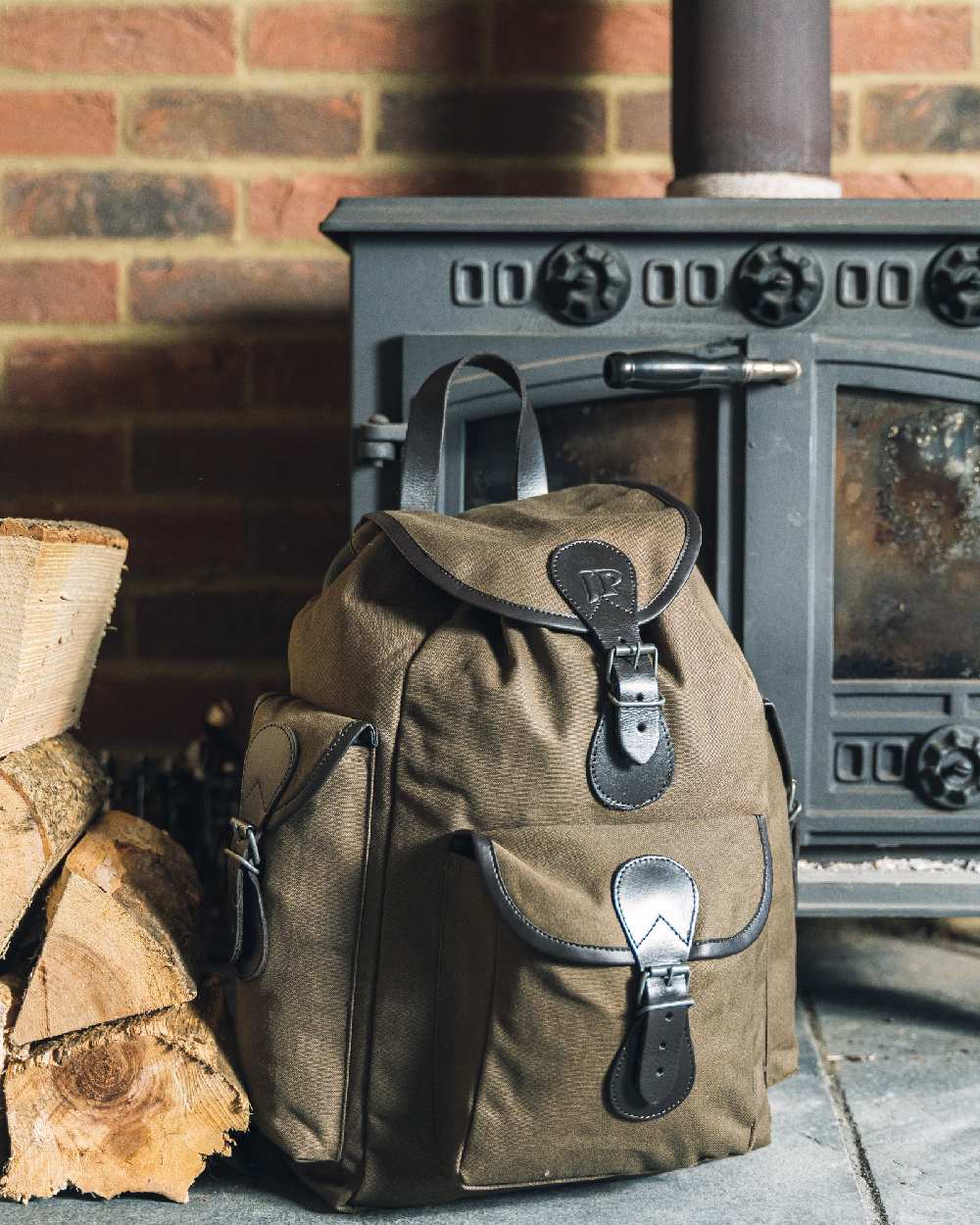 Green coloured Jack Pyke Canvas Day Pack on wall background