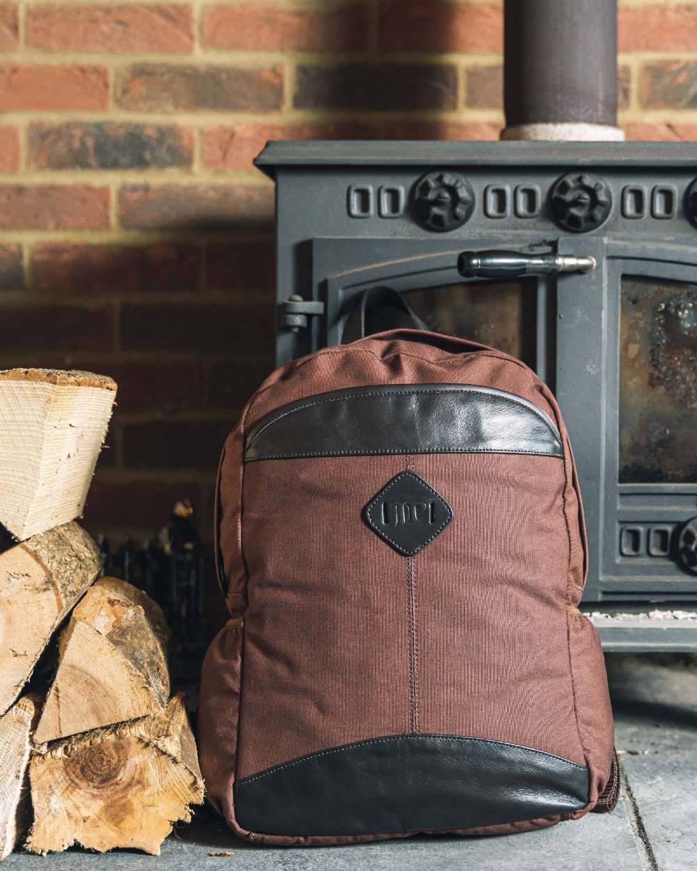 Brown coloured Jack Pyke Canvas Field Pack on brick wall background