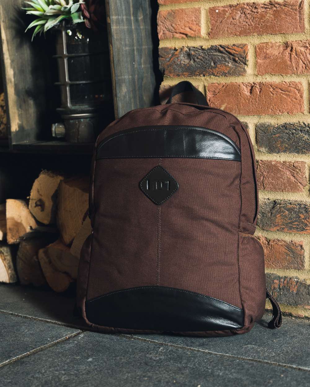 Brown coloured Jack Pyke Canvas Field Pack on brick wall background