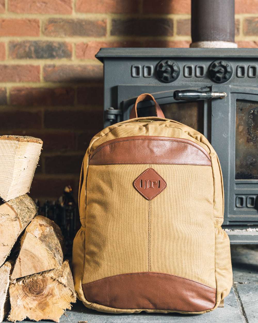 Fawn coloured Jack Pyke Canvas Field Pack on brick wall background