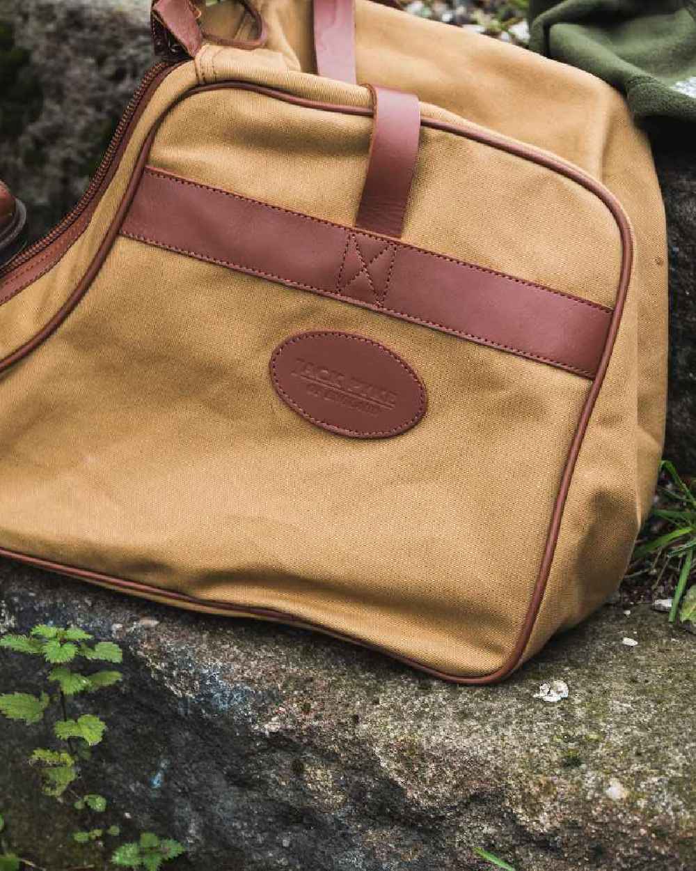 Fawn coloured Jack Pyke Canvas Walking Boot Bag on rock background