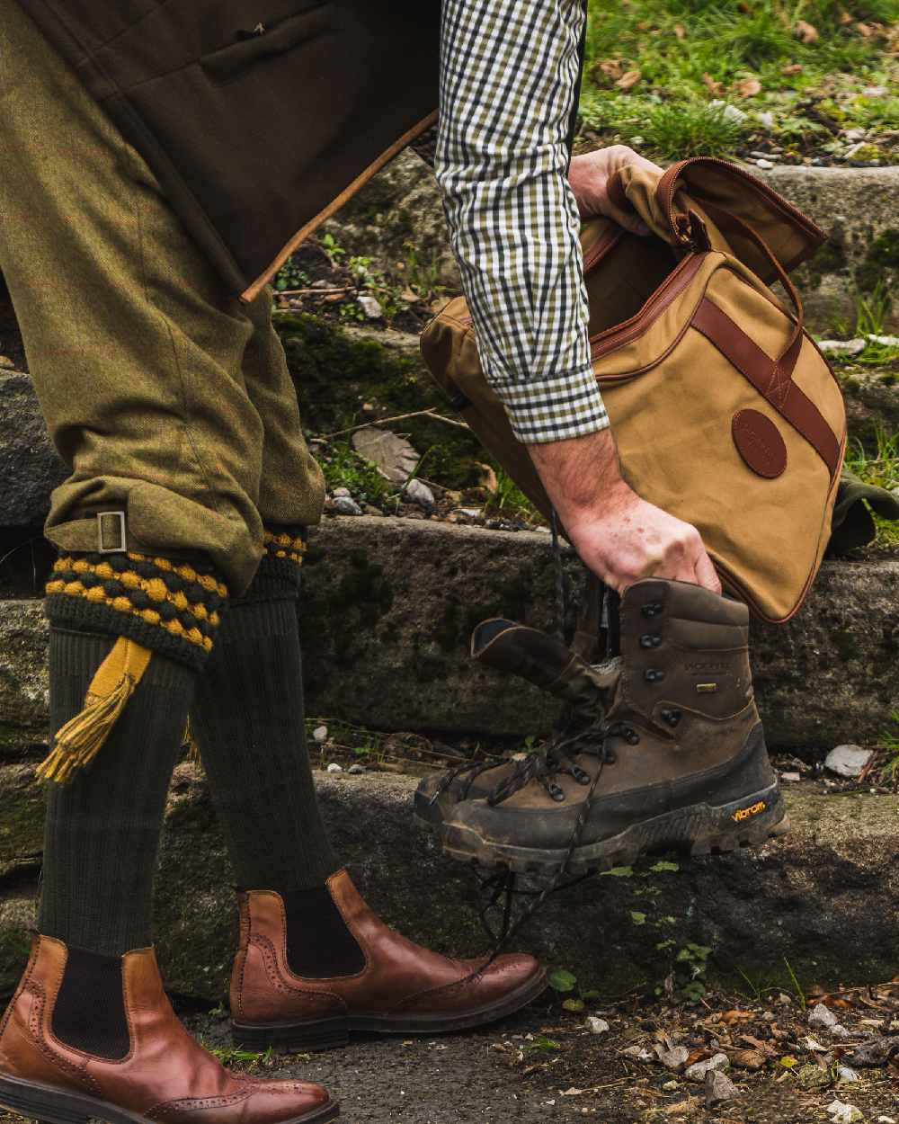 Fawn coloured Jack Pyke Canvas Walking Boot Bag on rock background