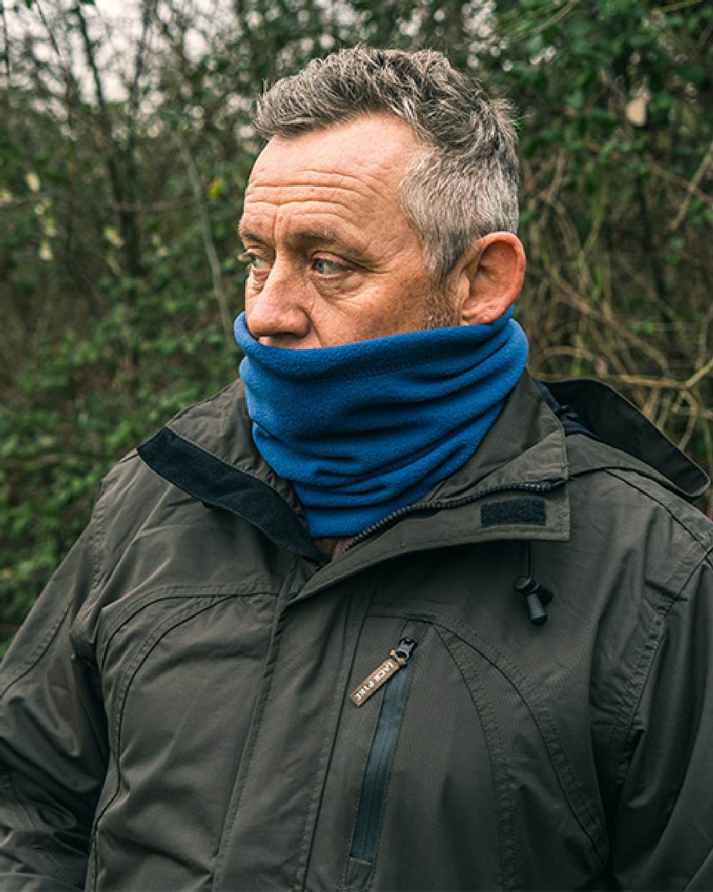 Denim coloured Jack Pyke Country Fleece Neck Gaiter on forest background