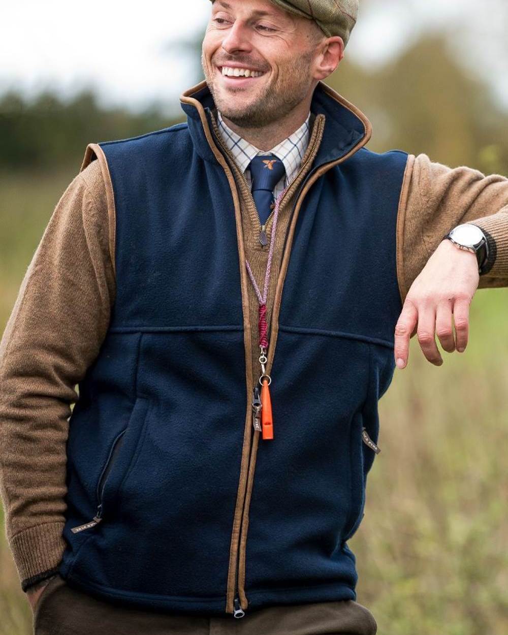 Navy coloured Jack Pyke Countryman Fleece Gilet on blurry background