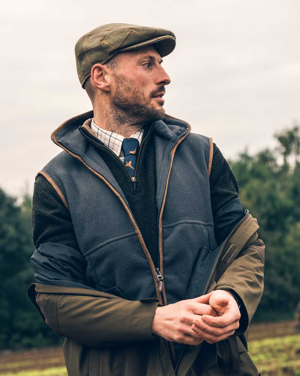 Navy coloured Jack Pyke Countryman Fleece Gilet on blurry background