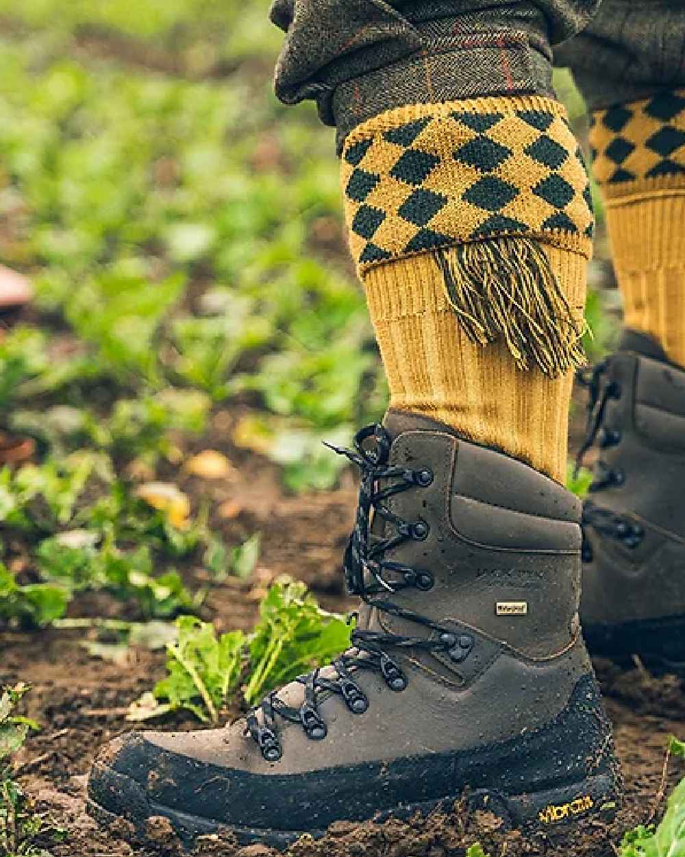 Brown coloured Jack Pyke Hunters Boots on soil background