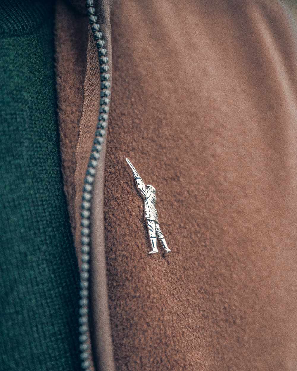 Countryman styled Jack Pyke Pin Badge on blurry background