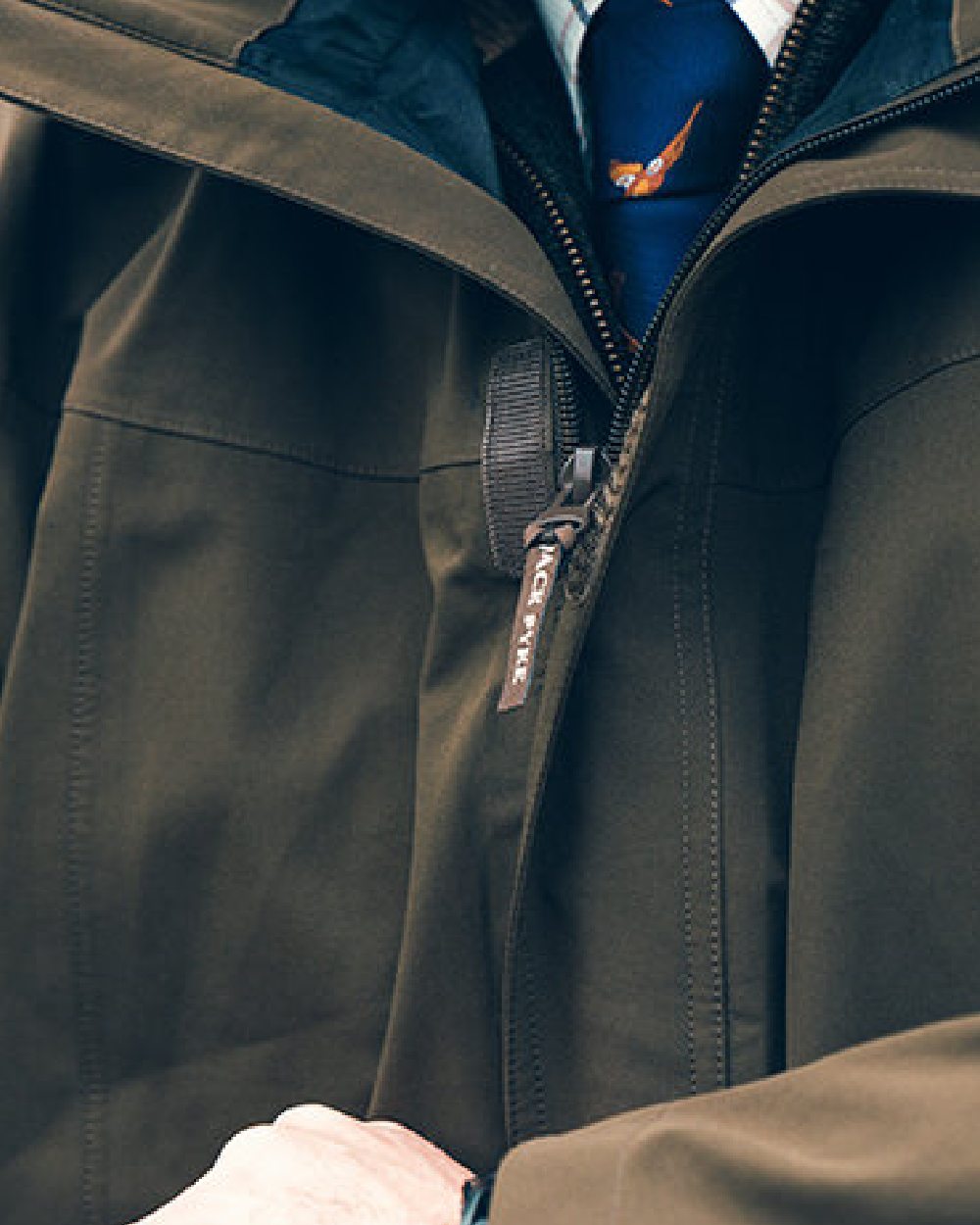 Green coloured Jack Pyke Pro-Lite Hunters Jacket on blurry background