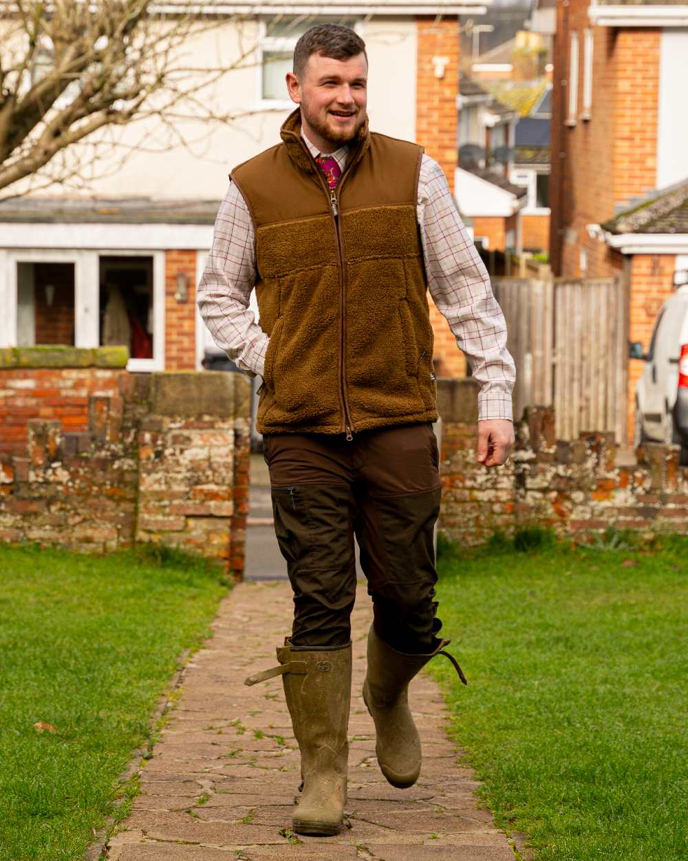 Camel coloured Jack Pyke Sherpa Fleece Gilet on house background