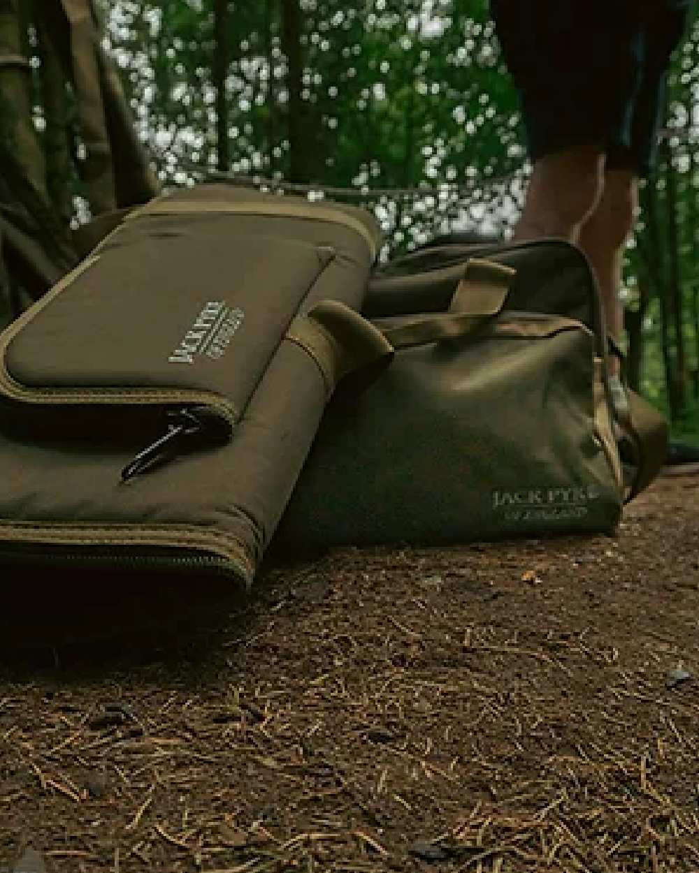 Green coloured Jack Pyke Sporting Gun Slip on forest background