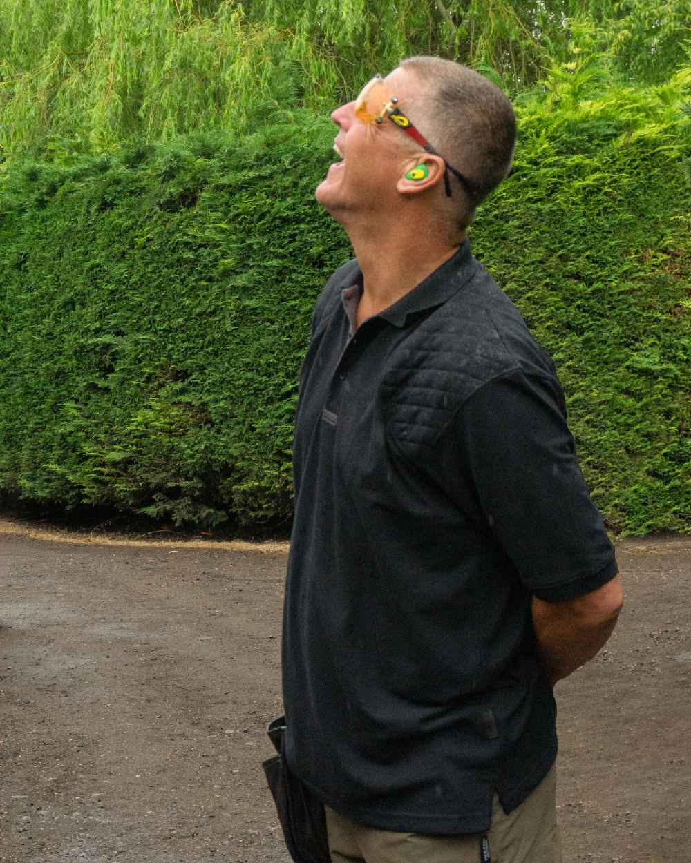 Black coloured Jack Pyke Sporting Polo Shirt on road background