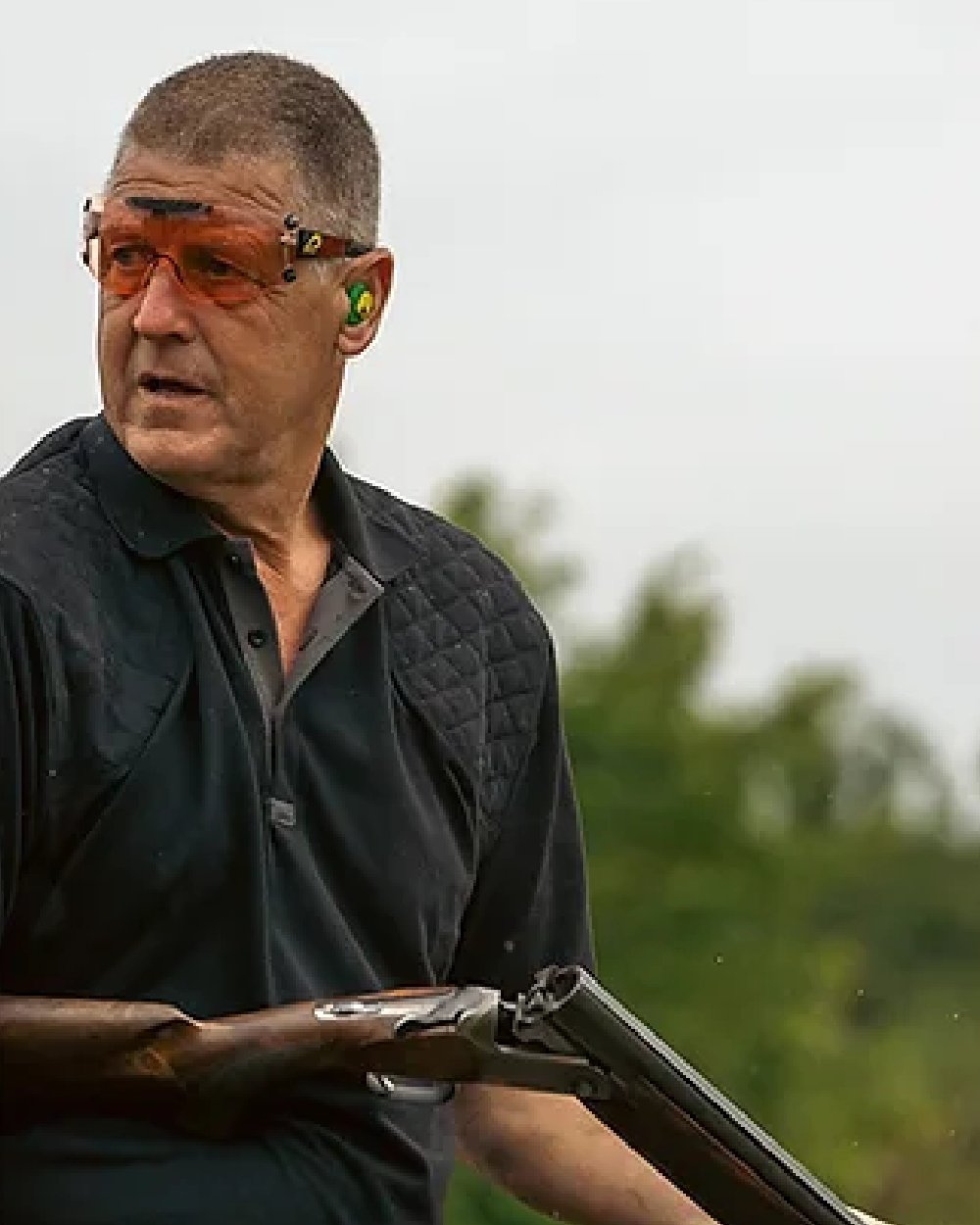 Black coloured Jack Pyke Sporting Polo Shirt on blurry background