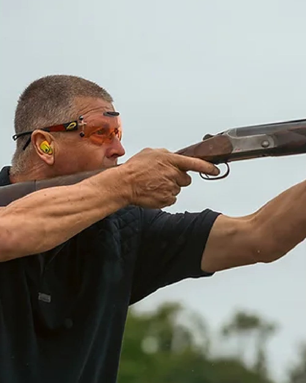 Black coloured Jack Pyke Sporting Polo Shirt on blurry background