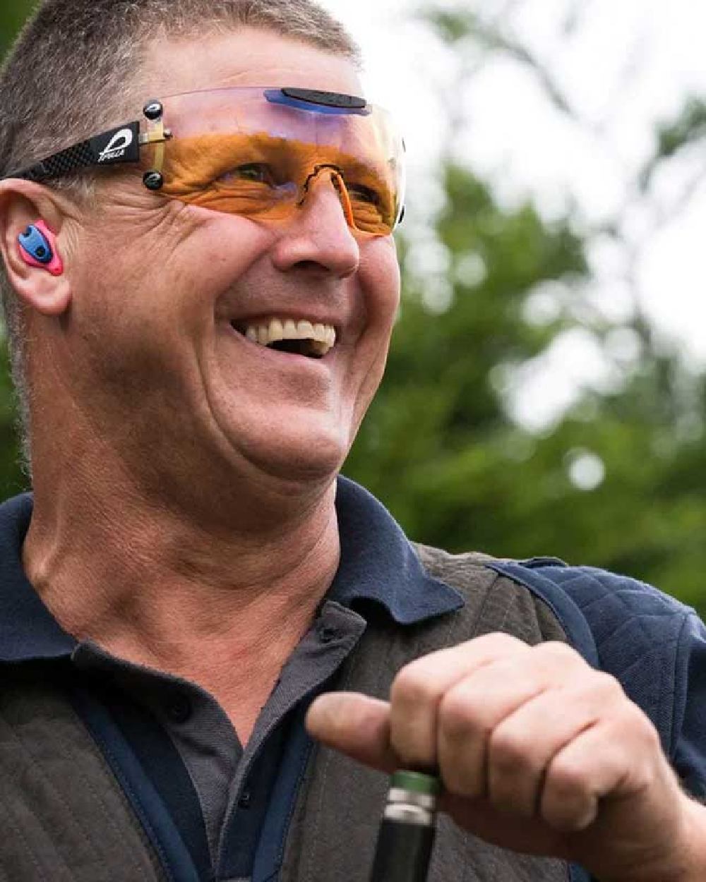 Navy coloured Jack Pyke Sporting Polo Shirt on blurry background