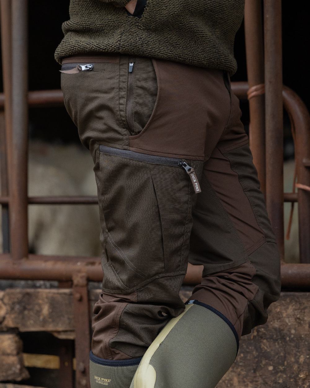 Brown coloured Jack Pyke Technical Hybrid Trousers on outdoor background