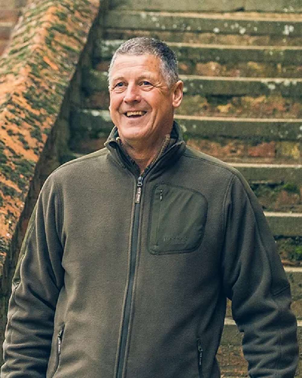 Green coloured Jack Pyke Weardale Fleece Jacket on stairs background