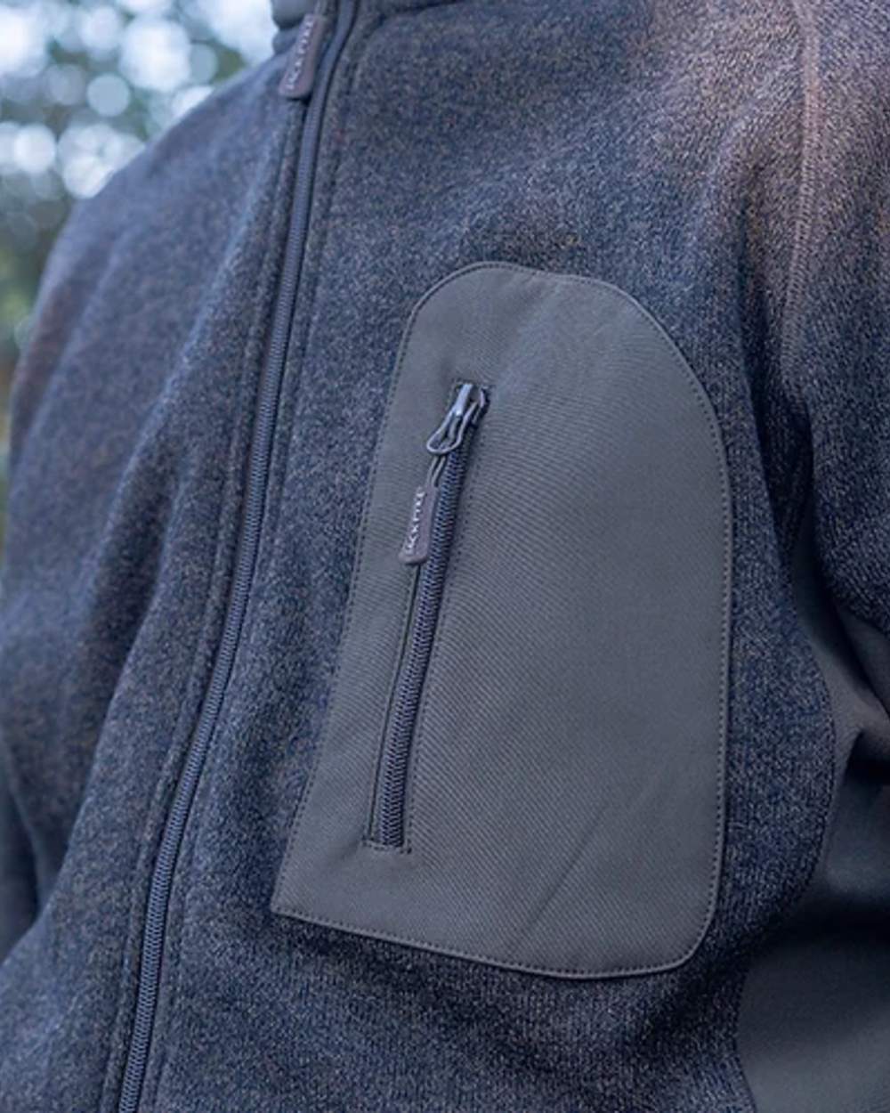 Green coloured Jack Pyke Weardale Knitted Jacket on blurry background