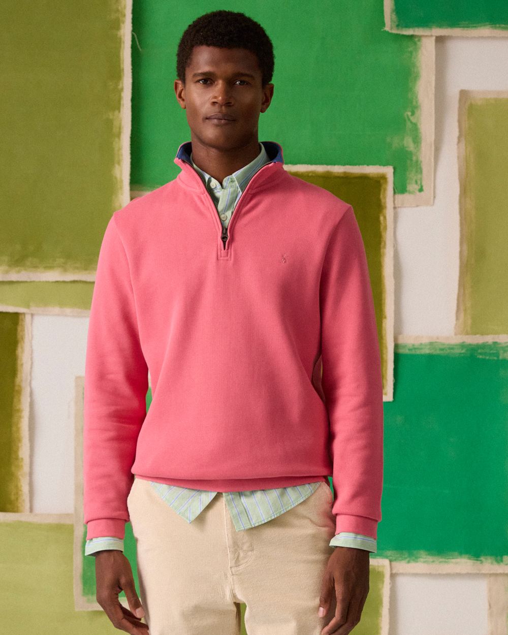 Pink coloured Joules Alistair Quarter Zip Cotton Sweatshirt on wall background