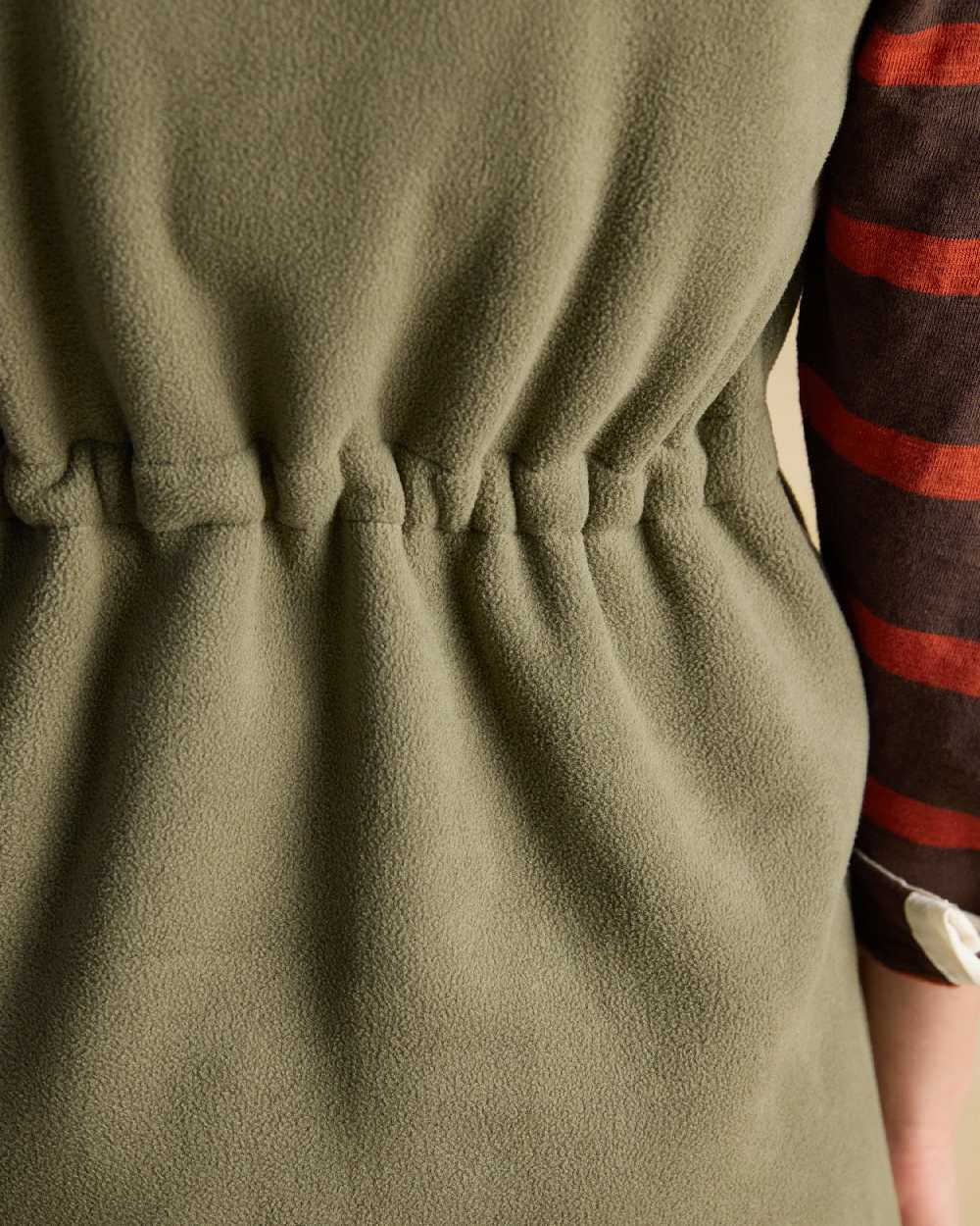 Light Green coloured Joules Heritage Longline Gilet on tan background