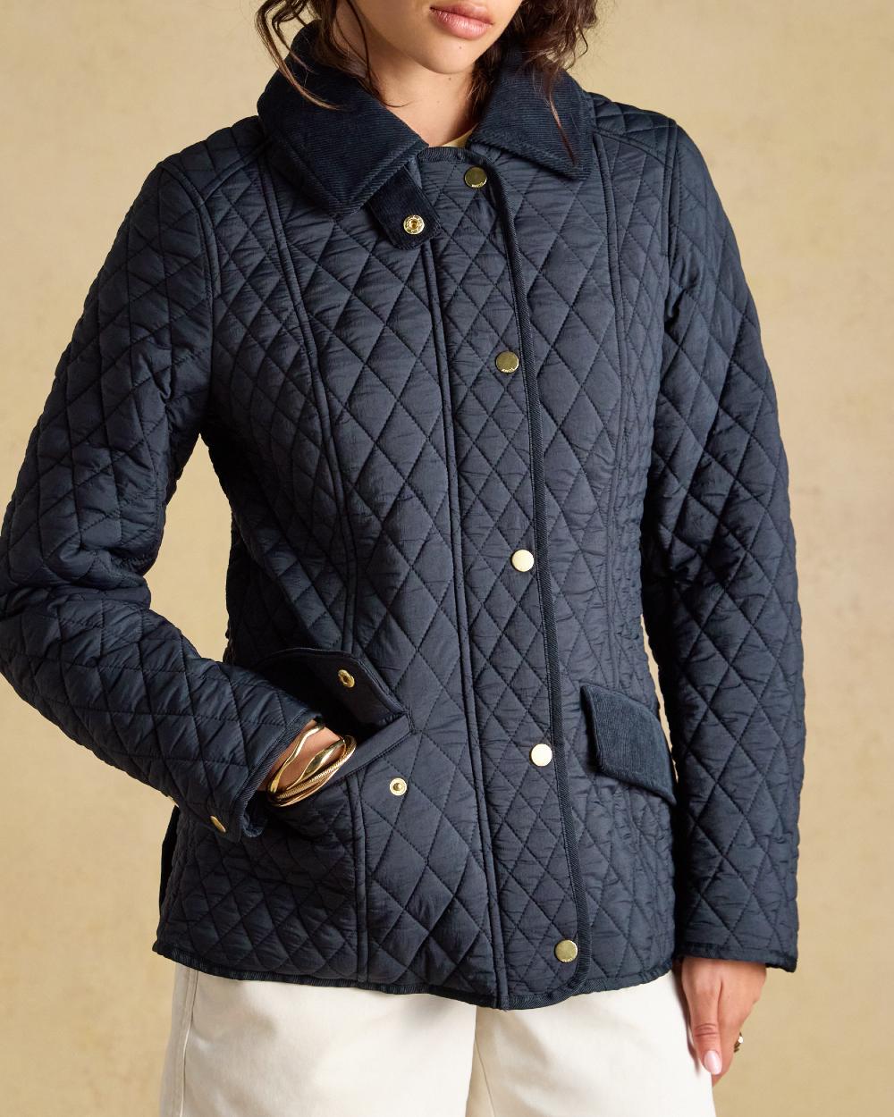 Navy coloured Joules Highclere Jacket on tan background