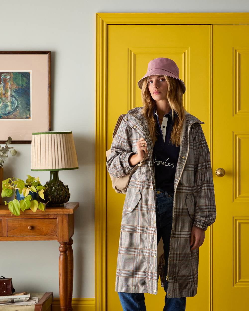 Dartmoor Check coloured Joules Holkham Waterproof Packable Raincoat With Hood on door background
