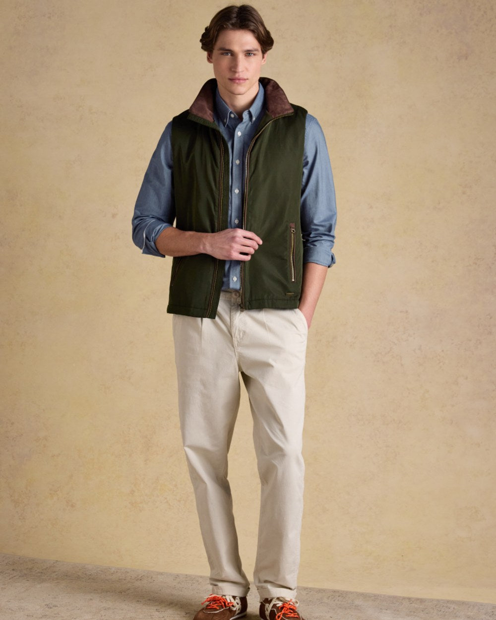 Green coloured Joules Mens Farnham Padded Fleece Lined Gilet on wall background
