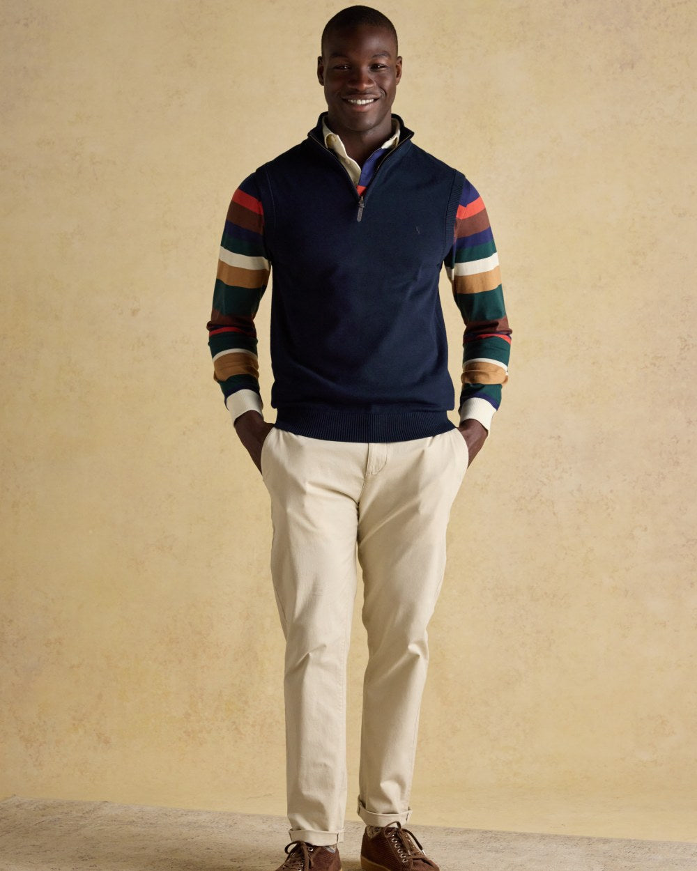 Navy coloured Joules Mens Hillside Quarter Zip Knitted Tank Top on wall background