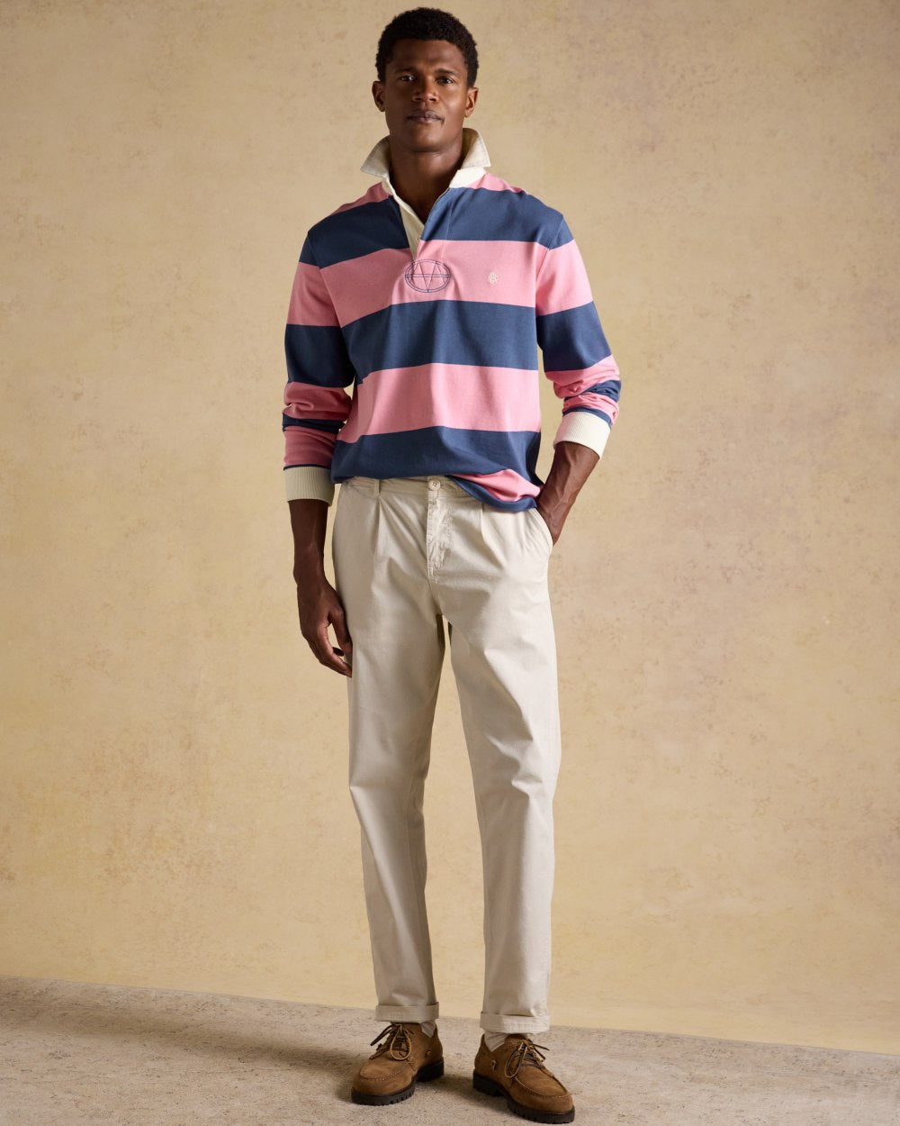Pink Blue Coloured Joules Mens Onside Rugby Shirt on wall background
