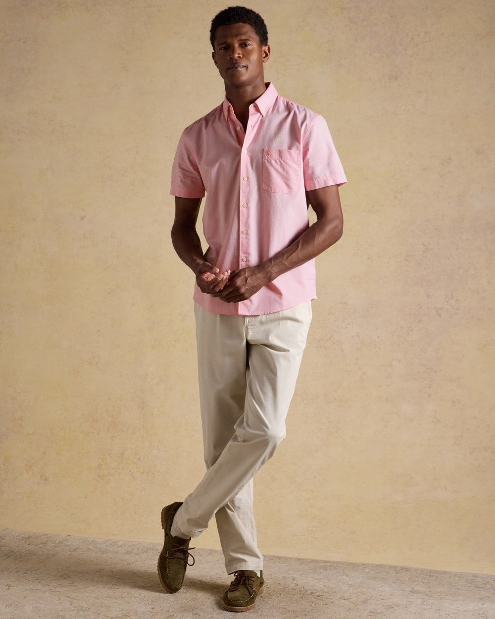 Pink coloured Joules Mens Oxford Short Sleeve Classic Fit Cotton Shirt on wall background