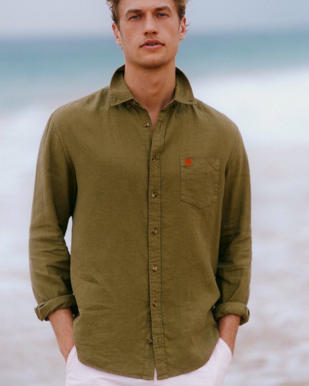 Khaki Green coloured Joules Mens Pure Linen Long Sleeve Classic Fit Shirt on sea background
