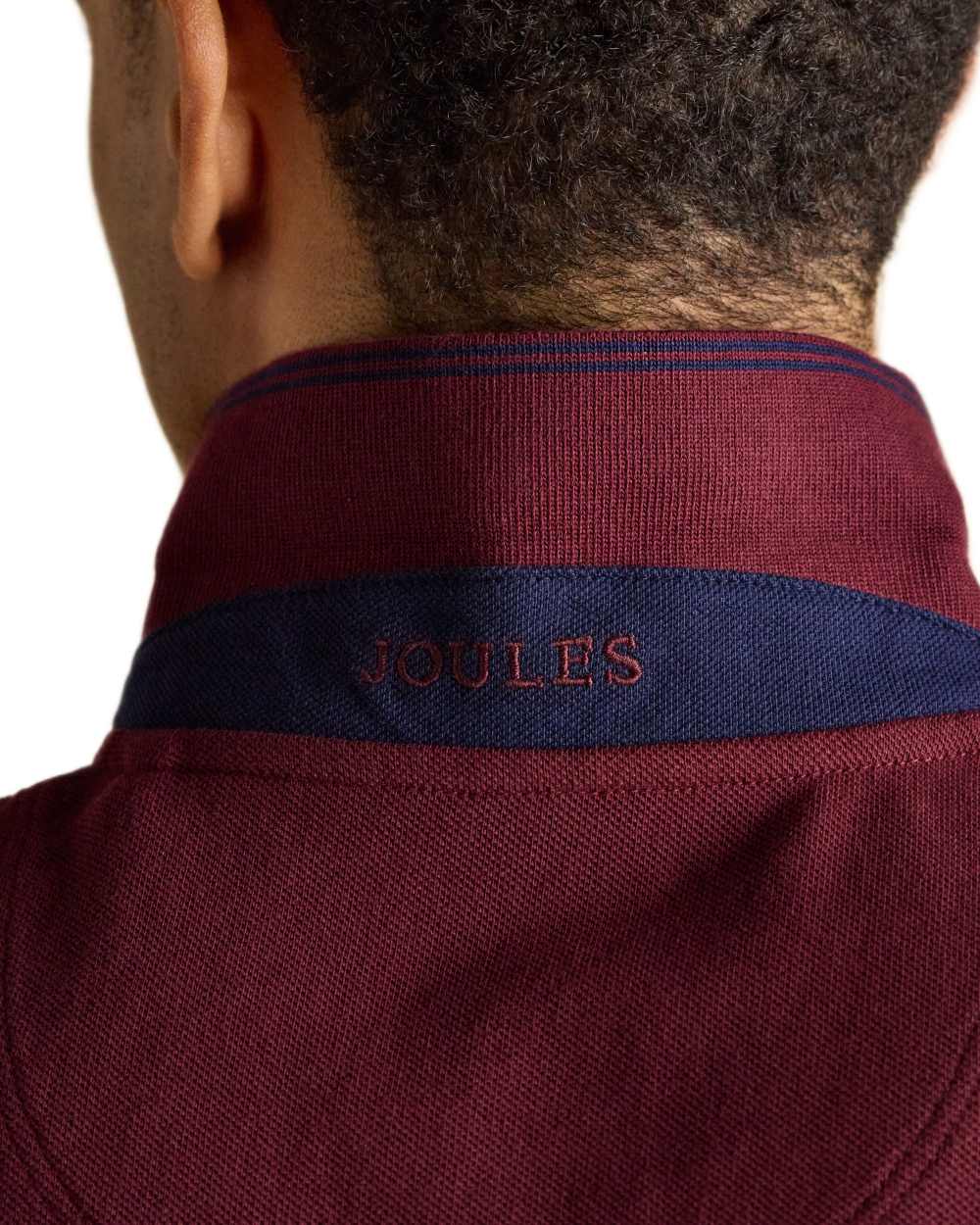 Burgundy coloured Joules Mens Woody Cotton Pique Polo Shirt on white background