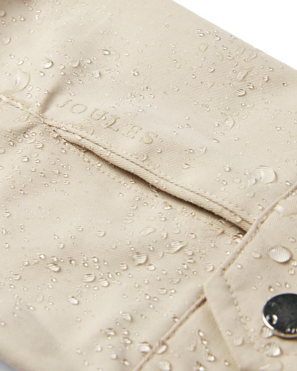 Neutral coloured Joules Portwell Waterproof Raincoat With Hood on white background