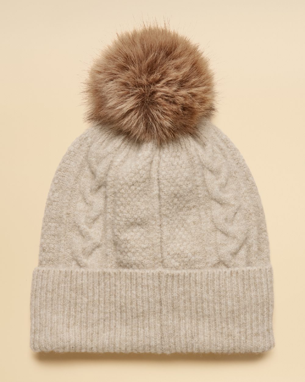 Oatmeal Coloured Joules Womens Cable Bobble Hat on Cream Background