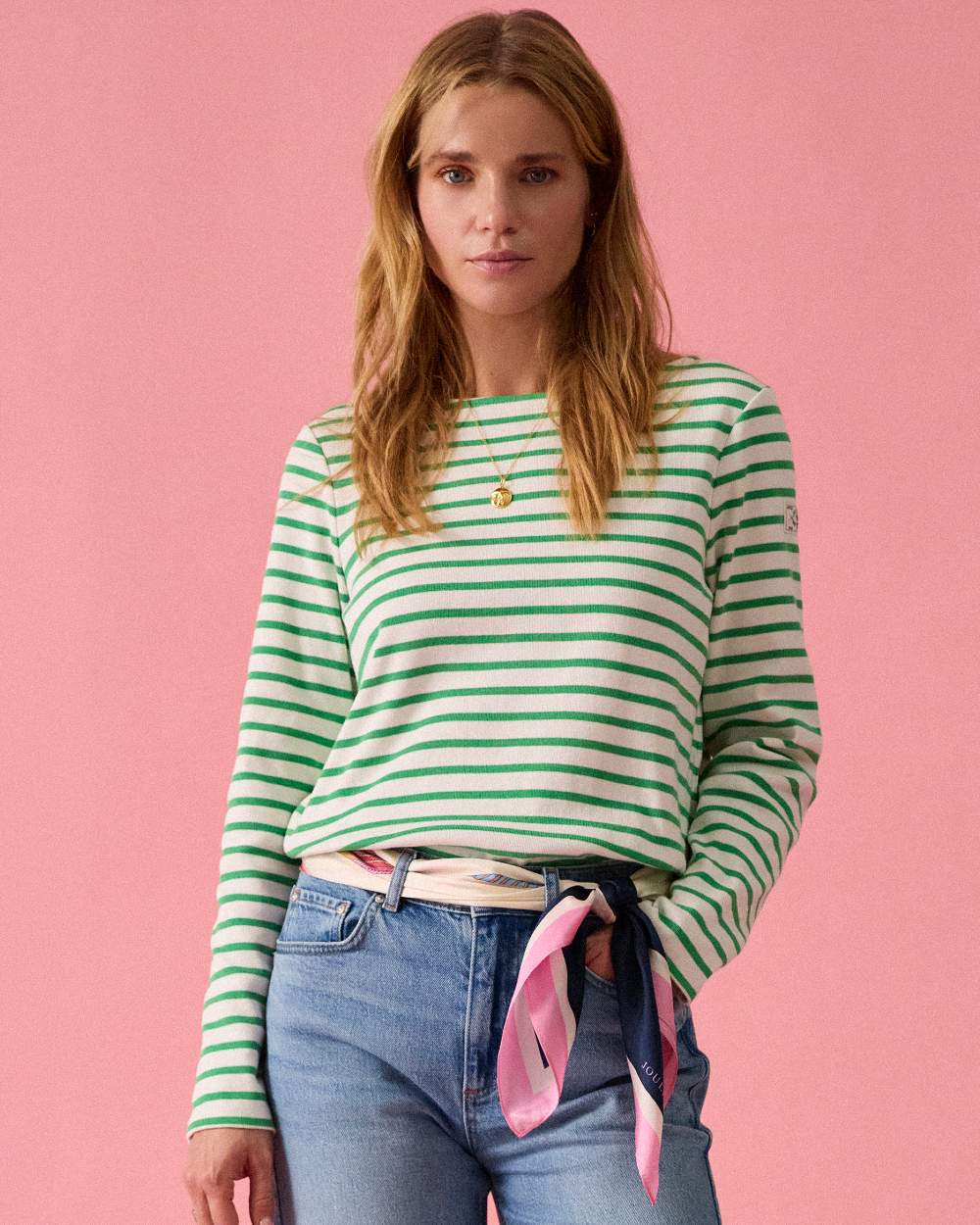 Green Stripe coloured Joules Womens Harbour Long Sleeve Striped Boat Neck Breton Top on wall background