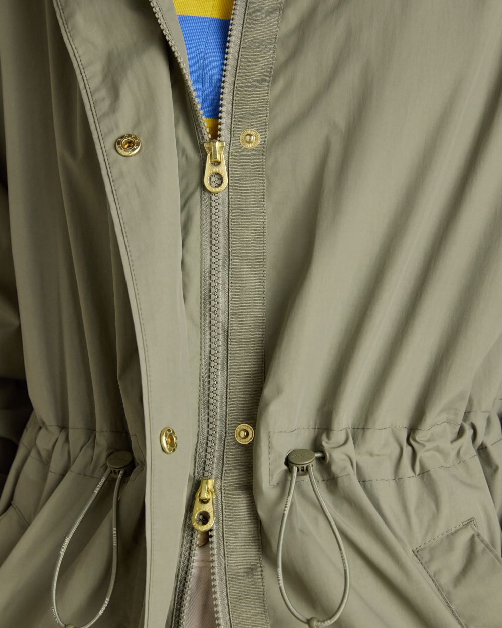 Khaki Green coloured Joules Womens Hensley Waterproof Longline Coat with Packable Hood on white background