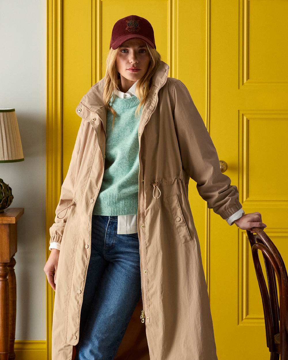 Tan Brown coloured Joules Womens Hensley Waterproof Longline Coat with Packable Hood on door background