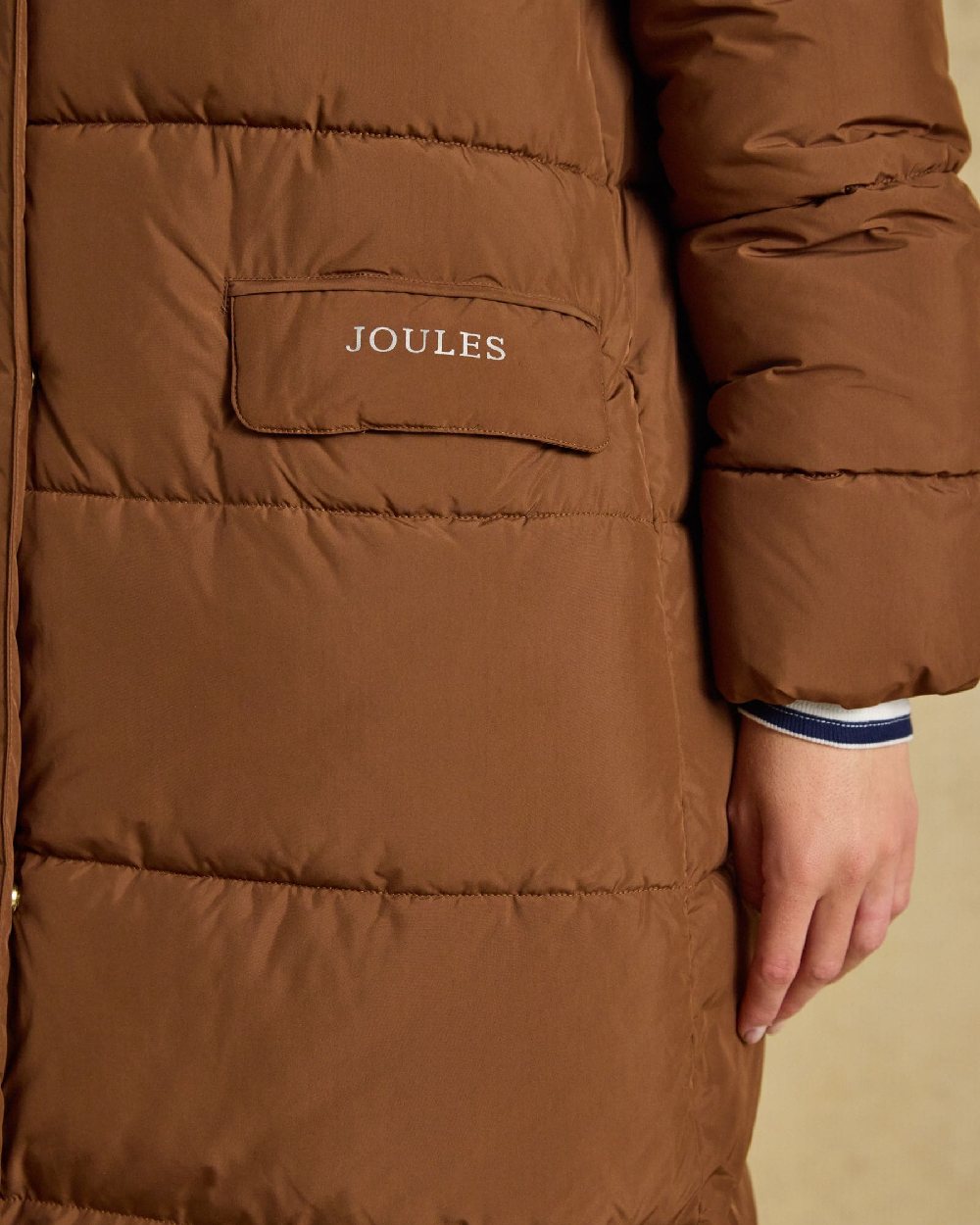 Brown Coloured Joules Womens Matchday Toffee Longline Showerproof Coat on Cream Background
