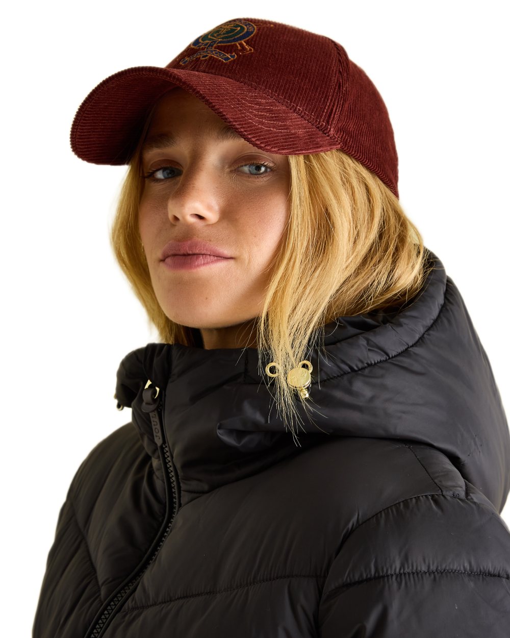 Black coloured Joules Womens Mid Length Showerproof Padded Coat With Hood on white background