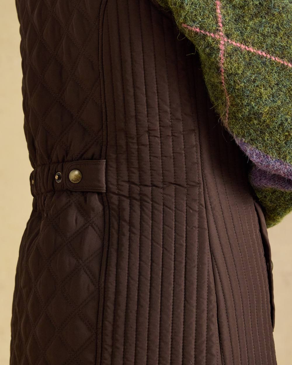 Chocolate Brown Coloured Joules Minx Showerproof Diamond Quilted Gilet on wall background