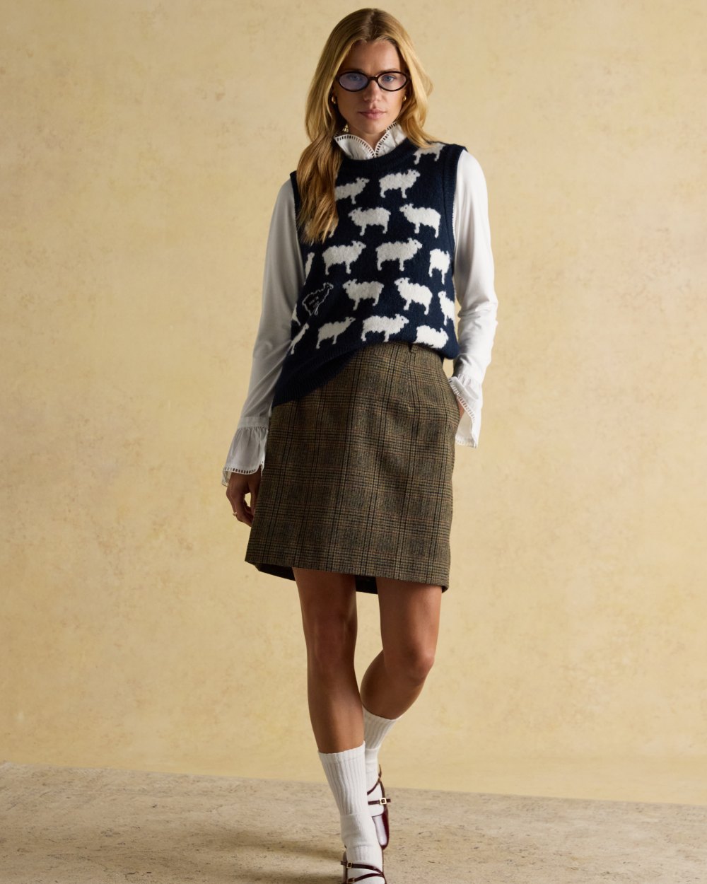 Navy coloured Joules Womens What The Flock Intarsia Knitted Vest on wall background