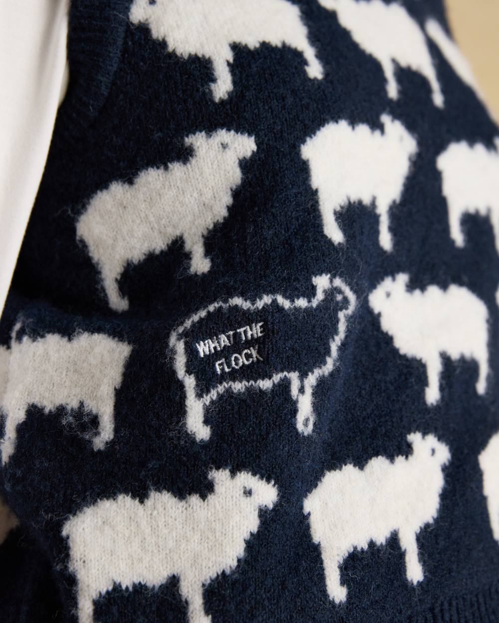 Navy coloured Joules Womens What The Flock Intarsia Knitted Vest on wall background