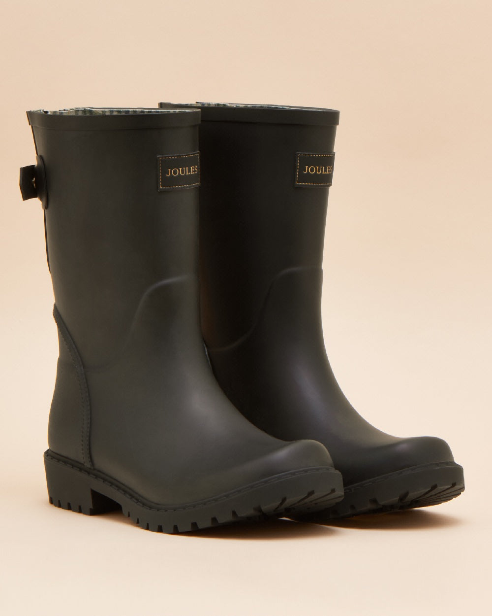 Black coloured Joules Womens Wistow Adjustable Mid Calf Wellies on tan background