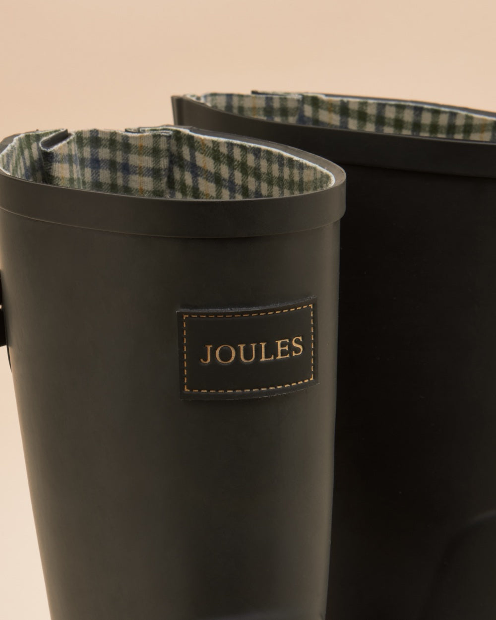 Black coloured Joules Womens Wistow Adjustable Mid Calf Wellies on tan background