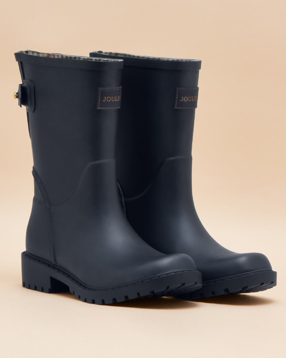 Navy Blue coloured Joules Womens Wistow Adjustable Mid Calf Wellies on tan background