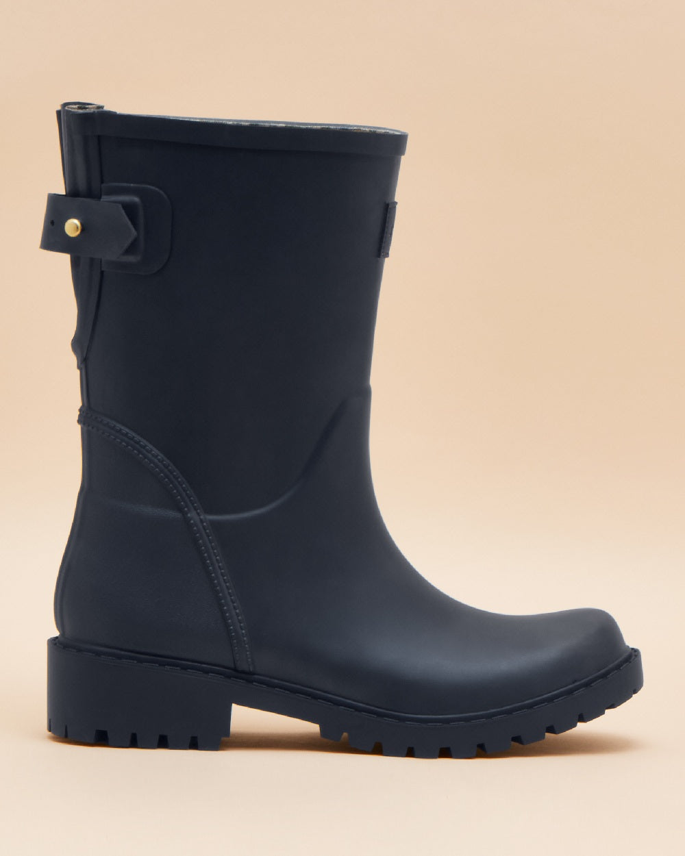 Navy Blue coloured Joules Womens Wistow Adjustable Mid Calf Wellies on tan background