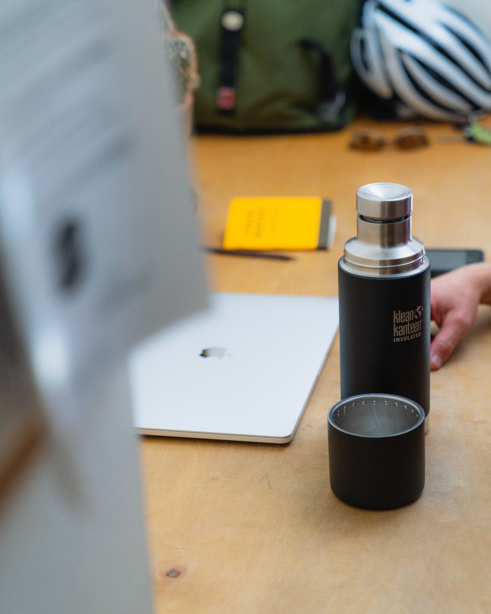 Black coloured Klean Kanteen Insulated TKPro Flask on desk background