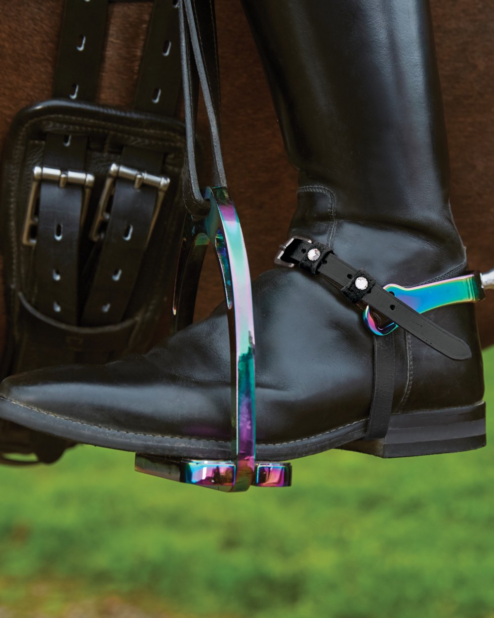 Rainbow coloured Korsteel Aluminium Stirrups on boot background
