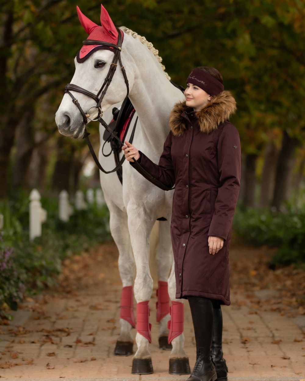 Damson Coloured LeMieux Anya Waterproof Riding Coat On A Tree Background