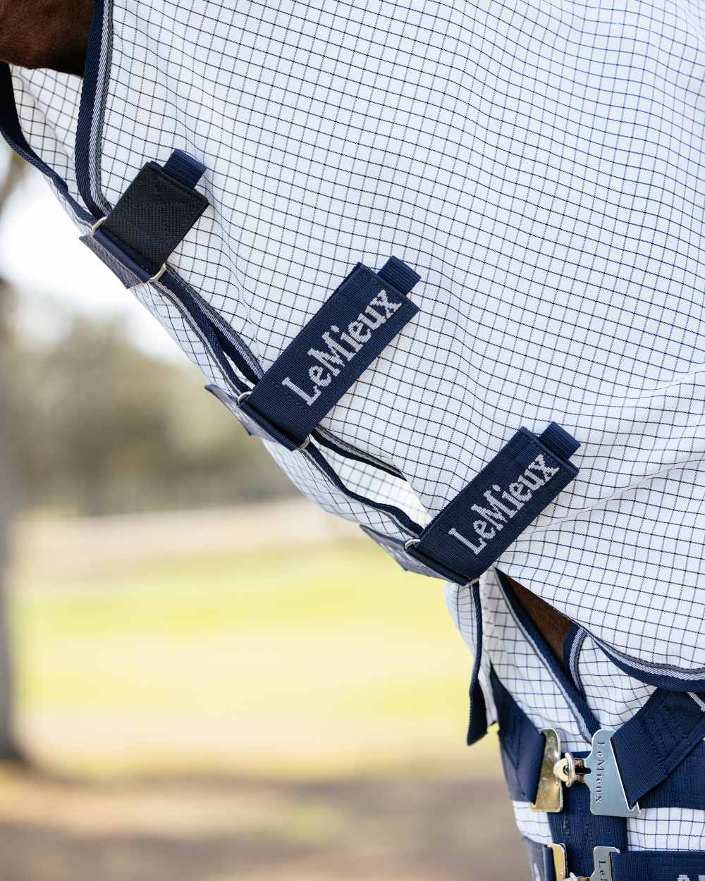 White coloured LeMieux Arika Field Rug on blurry background