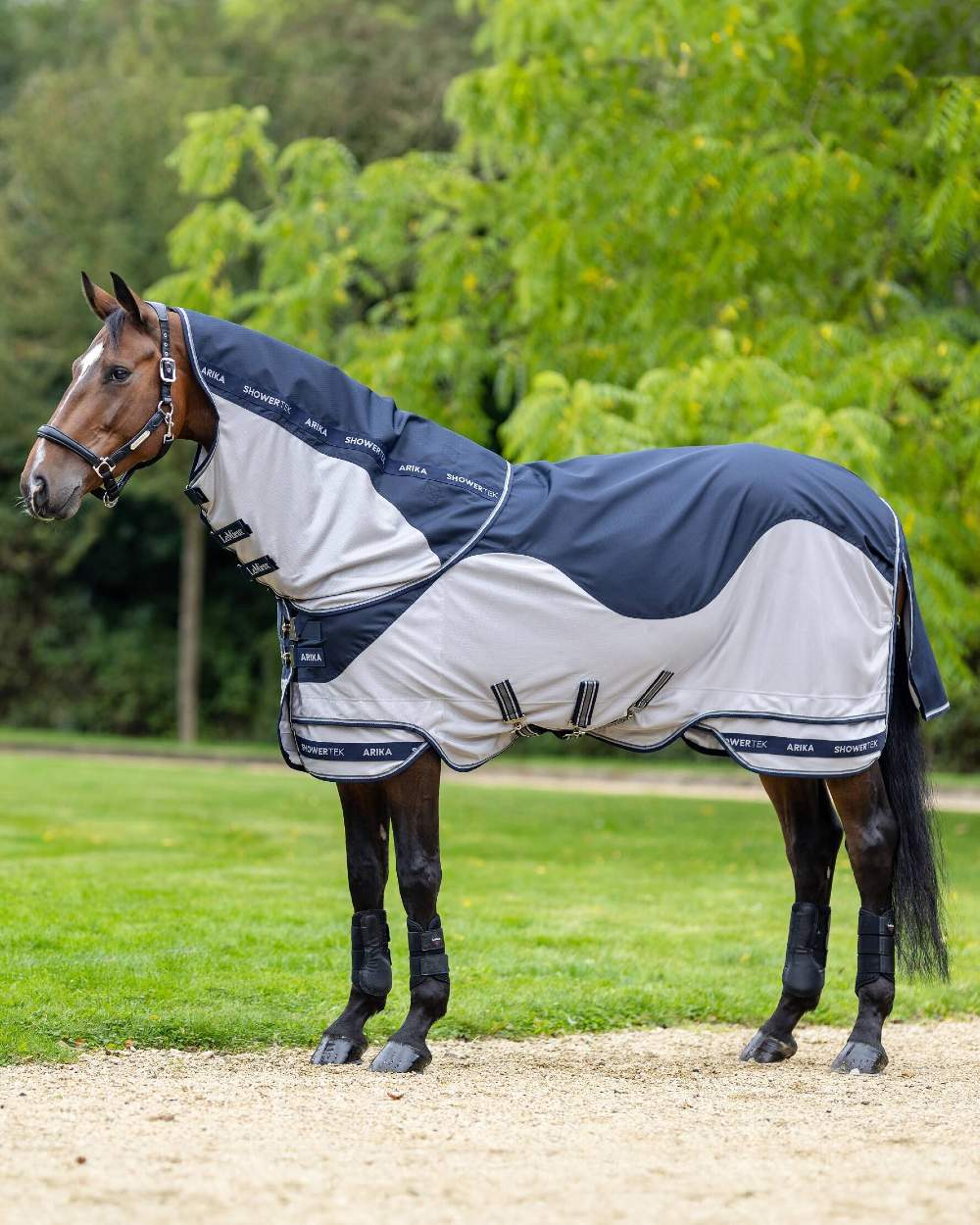 Navy coloured LeMieux Arika Shower Tek Fly Rug on blurry background